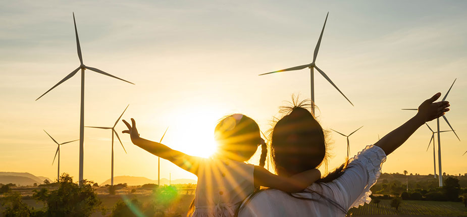 People waving at a field of wind turbines